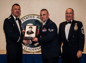 Col. Richard McComb, Joint Base Charleston commander, and Chief Master Sgt. Al Hannon, 628th Air Base Wing command chief, present the John L. Levitow Award to Senior Airman Wesley Stickels, from the 628th Logistics Readiness Squadron, during the Airman Leadership School Class graduation March 28, 2013, at Joint Base Charleston - Air Base, S.C. The Levitow award is given for a student's exemplary demonstration of excellence, both as a leader and a scholar. (U.S. Air Force photo/ Senior Airman Dennis Sloan)