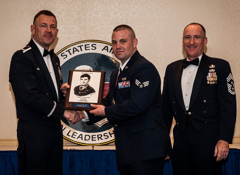Col. Richard McComb, Joint Base Charleston commander, and Chief Master Sgt. Al Hannon, 628th Air Base Wing command chief, present the John L. Levitow Award to Senior Airman Wesley Stickels, from the 628th Logistics Readiness Squadron, during the Airman Leadership School Class graduation March 28, 2013, at Joint Base Charleston - Air Base, S.C. The Levitow award is given for a student's exemplary demonstration of excellence, both as a leader and a scholar. (U.S. Air Force photo/ Senior Airman Dennis Sloan)