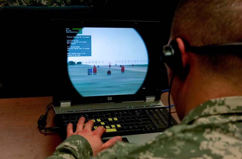 A Soldier aims at a target while using the Virtual Battle Space 2 computer simulator at Fort Eustis, Va., March 11, 2013. VBS2 is a fully interactive training system that provides a virtual environment suitable for a wide range of military training. (U.S. Air Force photo by Airman 1st Class R. Alex Durbin/Released)