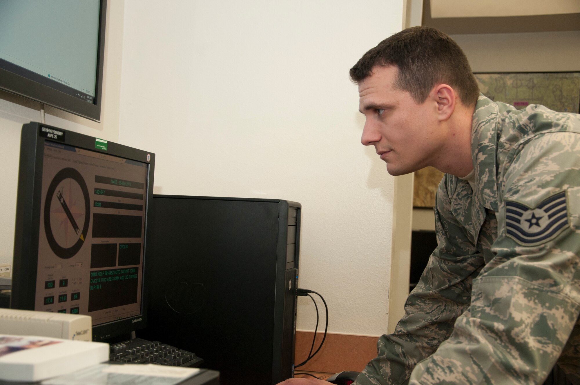Tech. Sgt. Mitchell Valentine, 47th Operations Support Squadron NCO in charge of weather operations, checks weather conditions at Laughlin Air Force Base, Texas, on March 28, 2013. Weather operators brief pilots on weather conditions that may affect their flight in order to improve safety and situational awareness. (U.S. Air Force photo by Airman 1st Class John D. Partlow)