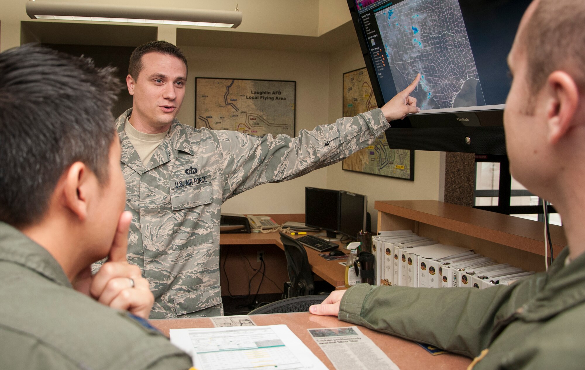 Tech. Sgt. Mitchell Valentine, 47th Operations Support Squadron NCO in charge of weather operations, performs a pre-flight weather briefing to pilots here at Laughlin Air Force Base, Texas, on March 28, 2013. The briefings inform pilots on weather conditions prior to their flight. Valentine recently earned the NCO of the Year award out of all weather operators in the Air Force. (U.S. Air Force photo by Airman 1st Class John D. Partlow)