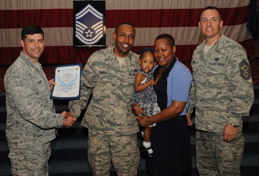 Master Sgt. Kelvin Samuel, 2nd Munitions Squadron, receives a certificate of promotion to Senior Master Sgt. From Col. Andrew Gebara, 2nd Bomb Wing commander, Air Force Global Strike Command, during the March Wing Promotion Ceremony on Barksdale Air Force Base, La., April 1, 2013. (U.S. Air Force photo/Senior Airman Sean Martin)