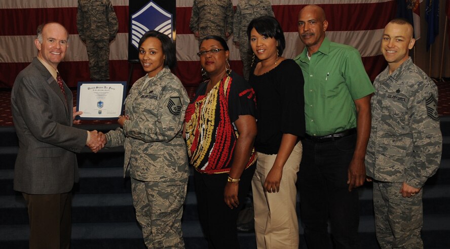 Tech. Sgt. Latosha Jackson, Air Force Global Strike Command, receives a certificate of promotion to Master Sgt. from Jeffrey Beene, Air Force Global Strike Command director of staff, during the March Wing Promotion Ceremony on Barksdale Air Force Base, La., April 1, 2013. (U.S. Air Force photo/Senior Airman Sean Martin)