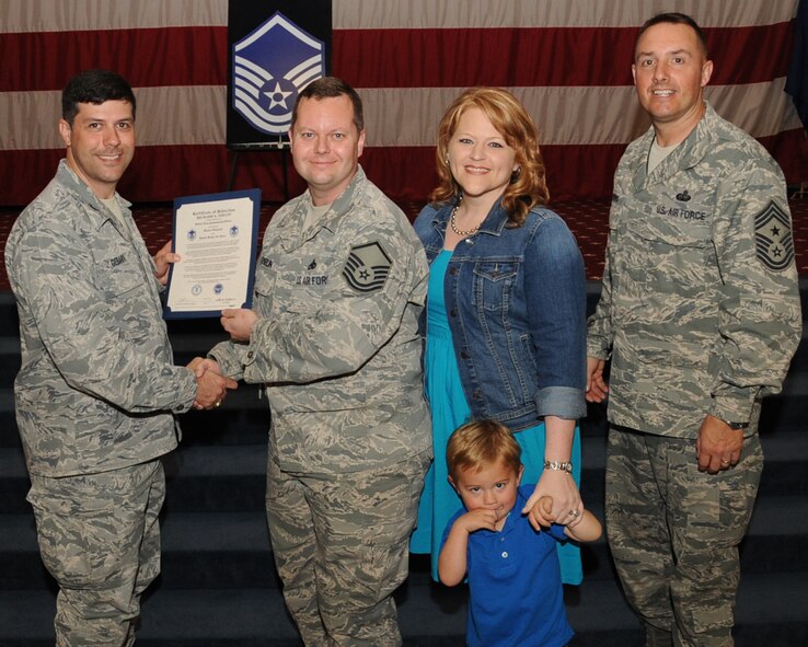 Tech. Sgt. Richard Oselin, 2nd Aircraft Maintenance Squadron, receives a certificate of promotion to Master Sgt. from Col. Andrew Gebara, 2nd Bomb Wing commander, during the March Wing Promotion Ceremony on Barksdale Air Force Base, La., April 1, 2013. (U.S. Air Force photo/Senior Airman Sean Martin)