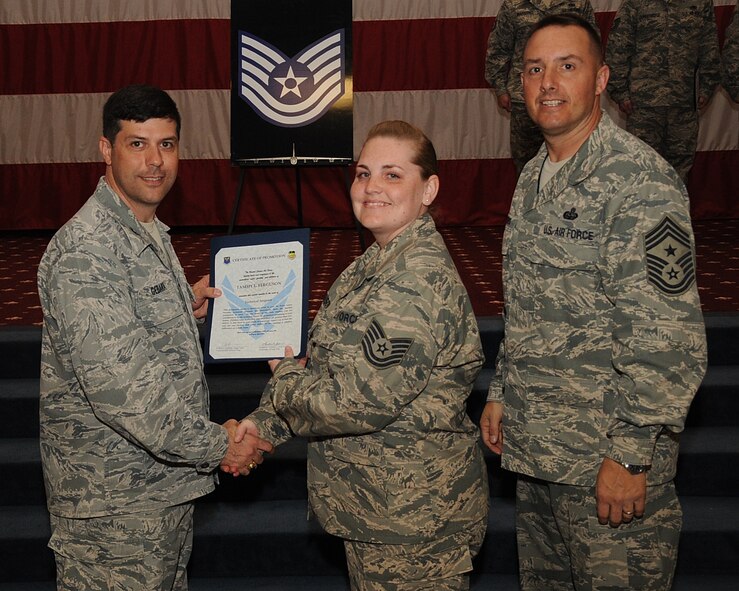 Staff Sgt. Tammy Ferguson, 2nd Maintenance Squadron, receives a certificate of promotion to Tech. Sgt. from Col. Andrew Gebara, 2nd Bomb Wing commander, during the March Wing Promotion Ceremony on Barksdale Air Force Base, La., April 1, 2013. (U.S. Air Force photo/Senior Airman Sean Martin)