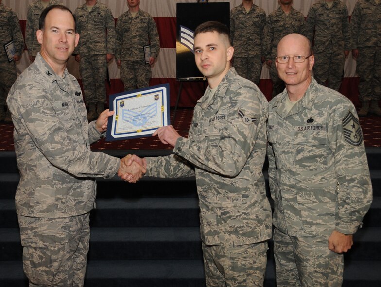 Airman 1st Class Tristan Bouchard, 608th Air and Space Operations Center, receives a certificate of promotion to Senior Airman from Col. Russell Mathers, 8th Air Force chief of staff, during the March Wing Promotion Ceremony on Barksdale Air Force Base, La., April 1, 2013. (U.S. Air Force photo/Senior Airman Sean Martin)