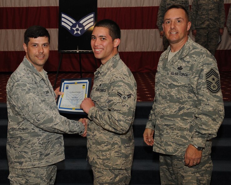 Airman 1st Class Niko Bryson, 2nd Munitions Squadron, receives a certificate of promotion to Senior Airman from Col. Andrew Gebara, 2nd Bomb Wing commander, during the March Wing Promotion Ceremony on Barksdale Air Force Base, La., April 1, 2013. (U.S. Air Force photo/Senior Airman Sean Martin)