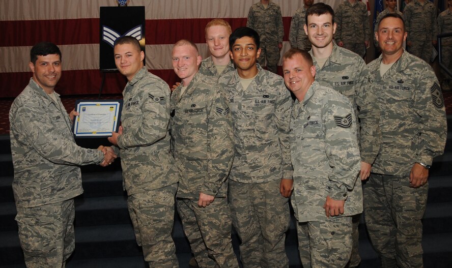Airman 1st Class Jacob Blythe, 2nd Maintenance Squadron, receives a certificate of promotion to Senior Airman from Col. Andrew Gebara, 2nd Bomb Wing commander, during the March Wing Promotion Ceremony on Barksdale Air Force Base, La., April 1, 2013. (U.S. Air Force photo/Senior Airman Sean Martin)