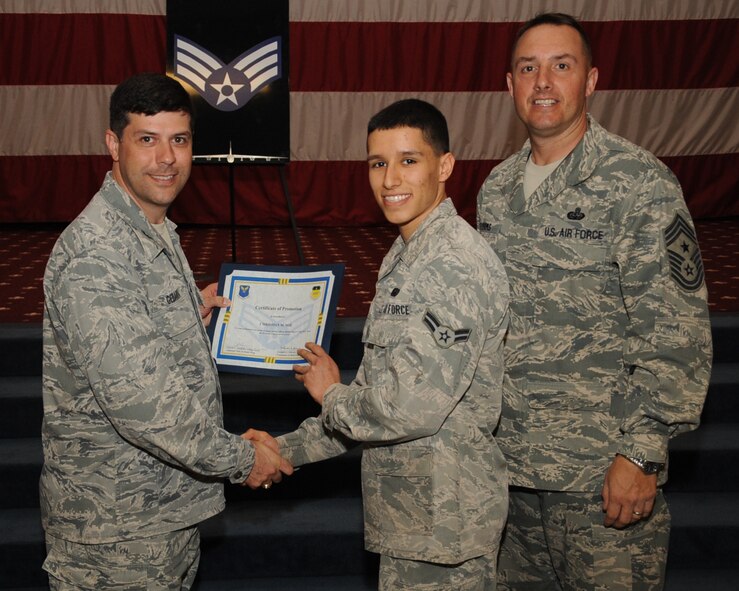 Airman 1st Class Christian Noe, 2nd Force Support Squadron, receives a certificate of promotion to Senior Airman from Col. Andrew Gebara, 2nd Bomb Wing commander, during the March Wing Promotion Ceremony on Barksdale Air Force Base, La., April 1, 2013. (U.S. Air Force photo/Senior Airman Sean Martin)