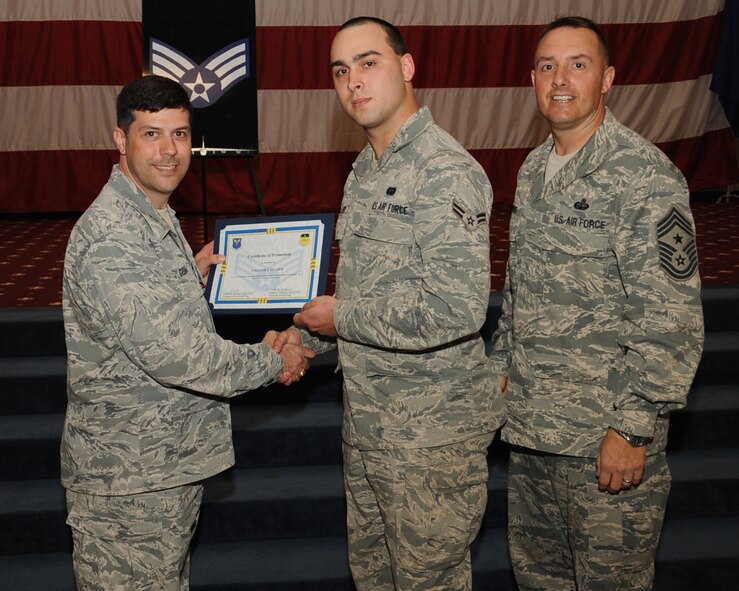 Airman 1st Class William Glazer, 2nd Communications Squadron, receives a certificate of promotion to Senior Airman from Col. Andrew Gebara, 2nd Bomb Wing commander, during the March Wing Promotion Ceremony on Barksdale Air Force Base, La., April 1, 2013. (U.S. Air Force photo/Senior Airman Sean Martin)