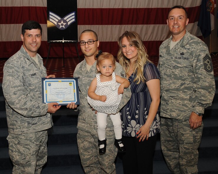 Airman 1st Class Joseph Pagan Jr., 2nd Bomb Wing, receives a certificate of promotion to Senior Airman from Col. Andrew Gebara, 2nd Bomb Wing commander, during the March Wing Promotion Ceremony on Barksdale Air Force Base, La., April 1, 2013. (U.S. Air Force photo/Senior Airman Sean Martin)