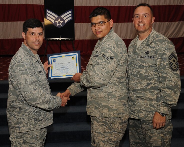 Airman 1st Class Michael Ruiz, 2nd Aircraft Maintenance Squadron, receives a certificate of promotion to Senior Airman from Col. Andrew Gebara, 2nd Bomb Wing commander, during the March Wing Promotion Ceremony on Barksdale Air Force Base, La., April 1, 2013. (U.S. Air Force photo/Senior Airman Sean Martin)