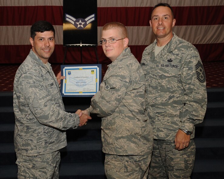 Airman Jesse Childress, 2nd Maintenance Squadron, receives a certificate of promotion to Airman 1st Class from Col. Andrew Gebara, 2nd Bomb Wing commander, during the March Wing Promotion Ceremony on Barksdale Air Force Base, La., April 1, 2013. (U.S. Air Force photo/Senior Airman Sean Martin)