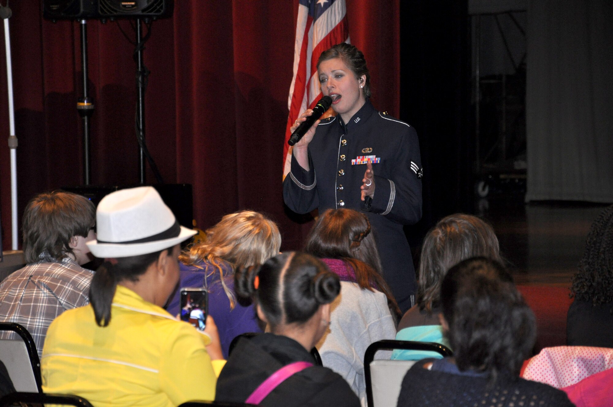 Senior Airman Carmen Emborski, Air Mobility Command Band of Mid-America singer, performs music selections from "Les Miserables" in front of about 70 children from Wolf Branch Middle School March 14, 2013, at the Valley of St. Louis-Scottish Rite Cathedral. Choral students from Wolf Branch Middle School were also working on "Les Miserables" and some of them sang with members of the band after the concert. (U.S. Air Force photo/Staff Sgt. Amber R. Kelly-Herard)