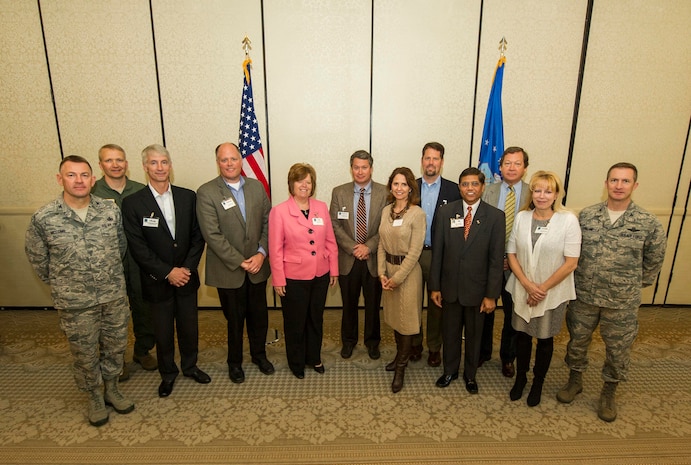 Col. Richard McComb (left), Joint Base Charleston commander, Col. Darren Hartford (second to left), 437th Airlift Wing commander, and Col. James Fontanella (right), 315th Airlift Wing commander, pose for a group photo with the members of the Advisory Council during the Honorary Commanders Induction Ceremony March 28, 2013, at Joint Base Charleston - Air Base, S.C. The Honorary Commanders program educates local community leaders about the various missions at JB Charleston. (U.S. Air Force photo/ Senior Airman George Goslin)