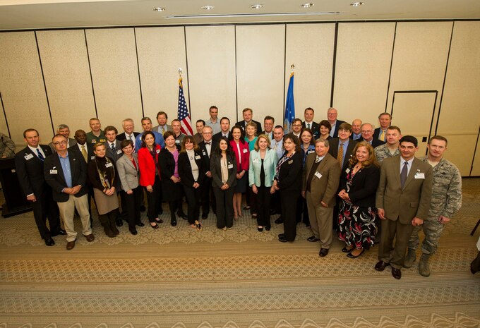 Col. Richard McComb, Joint Base Charleston commander, Col. Darren Hartford, 437th Airlift Wing commander, and Col. James Fontanella, 315th Airlift Wing commander, pose for a group photo with the former Honorary Commanders and the newly inducted Honorary Commanders during the Honorary Commanders Induction Ceremony March 28, 2013, at Joint Base Charleston - Air Base, S.C. The Honorary Commanders program educates local community leaders about the various missions at JB Charleston. (U.S. Air Force photo/ Senior Airman George Goslin)