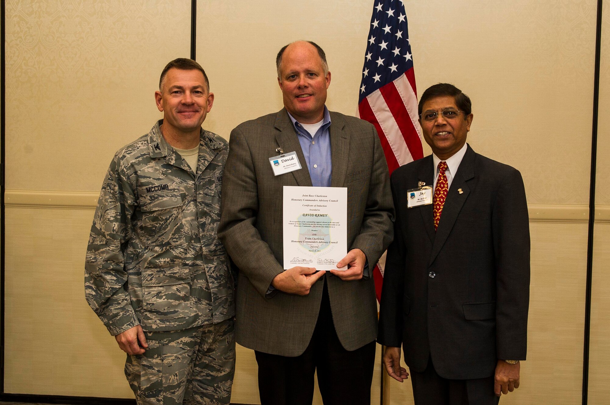 Col. Richard McComb (left), Joint Base Charleston commander, and Jay Patel (right), Advisory Council president, present former Honorary Commander David Ramey a certificate during the Honorary Commanders Induction Ceremony March 28, 2013, at Joint Base Charleston - Air Base, S.C. The Honorary Commanders program educates local community leaders about the various missions at JB Charleston. (U.S. Air Force photo/ Senior Airman George Goslin)