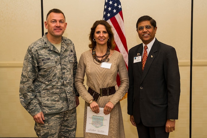 Col. Richard McComb (left), Joint Base Charleston commander, and Jay Patel (right), Advisory Council president, present former Honorary Commander Michelle Kelly a certificate for her service during the Honorary Commanders Induction Ceremony March 28, 2013, at Joint Base Charleston - Air Base, S.C. The Honorary Commanders program educates local community leaders about the various missions at JB Charleston. (U.S. Air Force photo/ Senior Airman George Goslin)