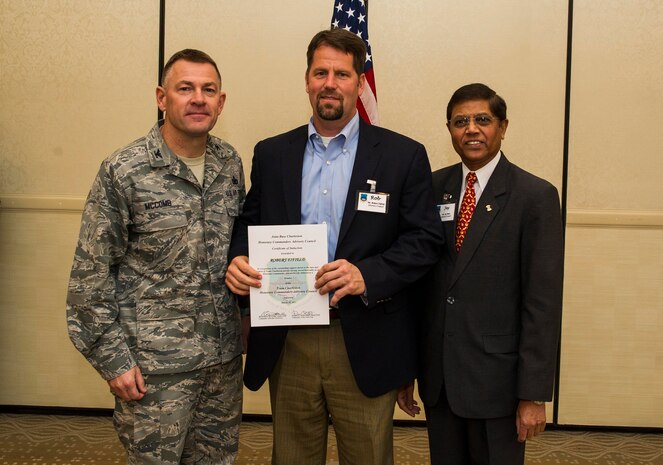 Col. Richard McComb (left), Joint Base Charleston commander, and Jay Patel (right), Advisory Council president, present former Honorary Commander Rob Fifield a certificate for his service during the Honorary Commanders Induction Ceremony March 28, 2013, at Joint Base Charleston - Air Base, S.C. The Honorary Commanders program educates local community leaders about the various missions at JB Charleston. (U.S. Air Force photo/ Senior Airman George Goslin)