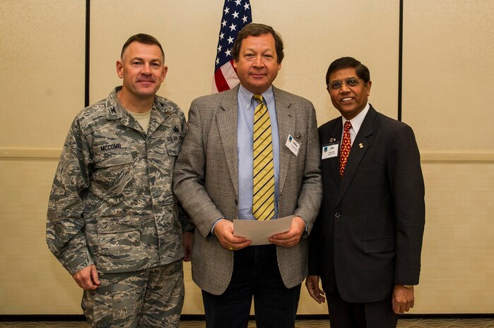 Col. Richard McComb (left), Joint Base Charleston commander, and Jay Patel (right), Advisory Council president, present former Honorary Commander Michael Allen a certificate for his service during the Honorary Commanders Induction Ceremony March 28, 2013, at Joint Base Charleston - Air Base, S.C. The Honorary Commanders program educates local community leaders about the various missions at JB Charleston. (U.S. Air Force photo/ Senior Airman George Goslin)