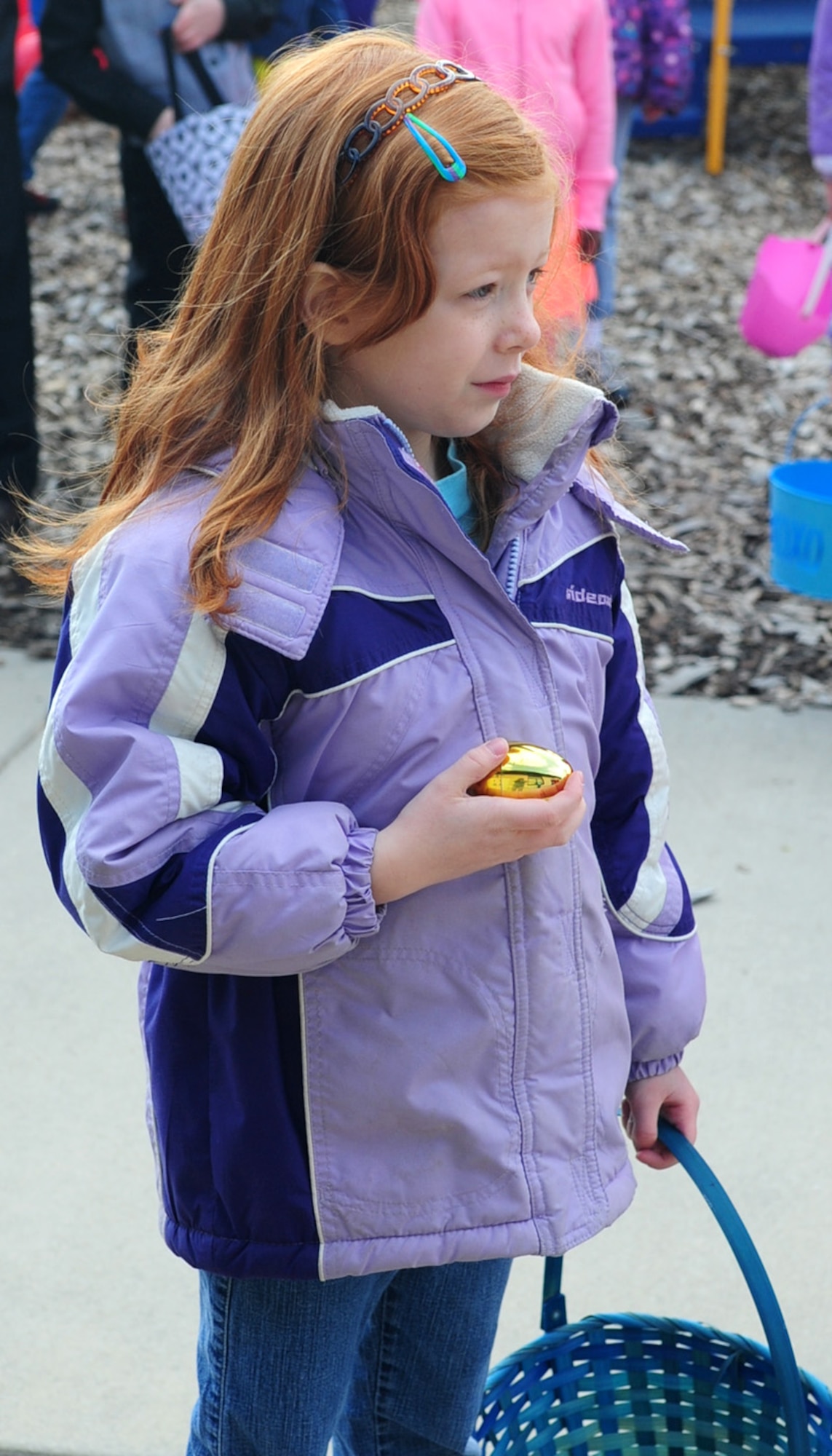 Morgan Hoyme, one of three children to find a golden egg, waits to get her prize at the Easter Egg Hunt March 30, 2013, at the Youth Center on Dover Air Force Base, Del. The Easter Egg Hunt was for children ages 2-12. This is one of several fun family events the Youth Center provides for military families. (U.S. Air Force photo/Airman 1st Class Ashlin Federick)