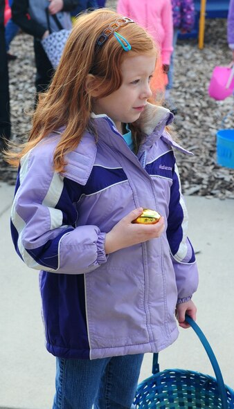Morgan Hoyme, one of three children to find a golden egg, waits to get her prize at the Easter Egg Hunt March 30, 2013, at the Youth Center on Dover Air Force Base, Del. The Easter Egg Hunt was for children ages 2-12. This is one of several fun family events the Youth Center provides for military families. (U.S. Air Force photo/Airman 1st Class Ashlin Federick)
