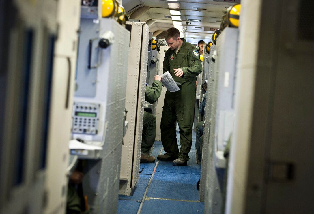 Maj. Joseph receives a status report on a training exercise for the JSTARS during a flight, Feb. 12, 2013, over the Florida coastline. Maj. Joseph is a senior director with 461 Air Control Wing. (U.S. Air Force photo/Senior Airman Andrew Lee)