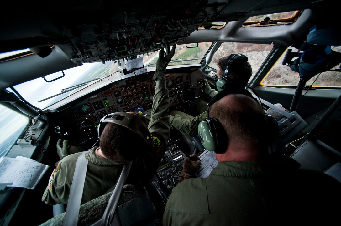 Air craft commander Maj. Ben (left) flies an E-8 Charlie along with co-pilot Capt. Ryan (top right), as flight engineer Senior Master Sgt. Curtis monitors the aircrafts systems during a training exercise for the Joint Surveillance and Target Attack Radar System at Warner Robins Air Force Base, Ga., Feb. 13, 2013.  (U.S. Air Force photo/Senior Airman Andrew Lee)