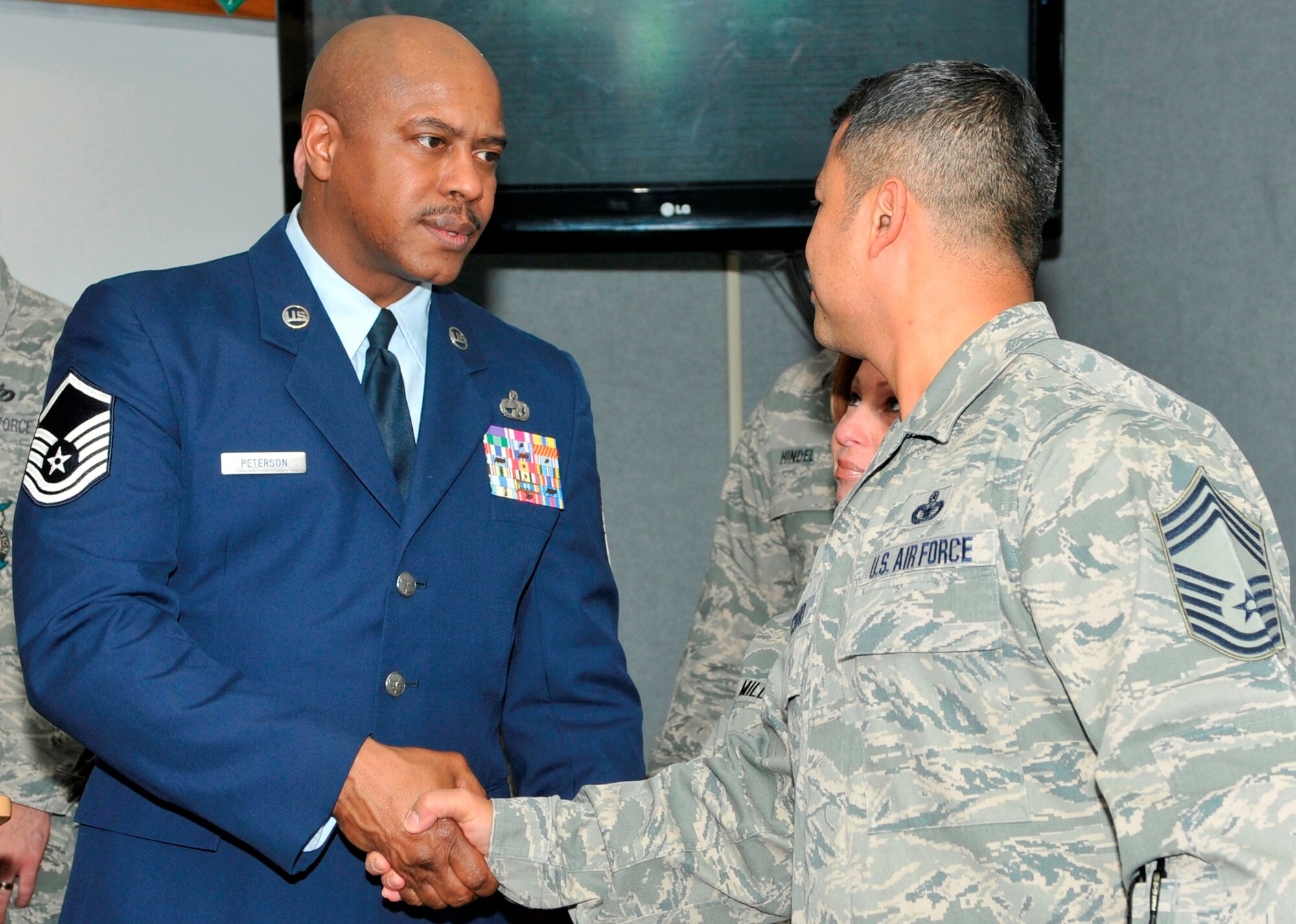 Master Sgt. Charlie Peterson, 127th Logistics Readiness Squadron vehicle operator at Selfridge Air National Guard Base, Mich., shakes Chief Master Sgt. Joseph Pritchard’s hand on March 27at the Airey NCO Academy on Tyndall Air Force Base. The Airey NCO Academy class 13-3 dedicated their Guardian Flight room to Sergeant Peterson. (U.S. Air Force Photo by Susan Trahan)