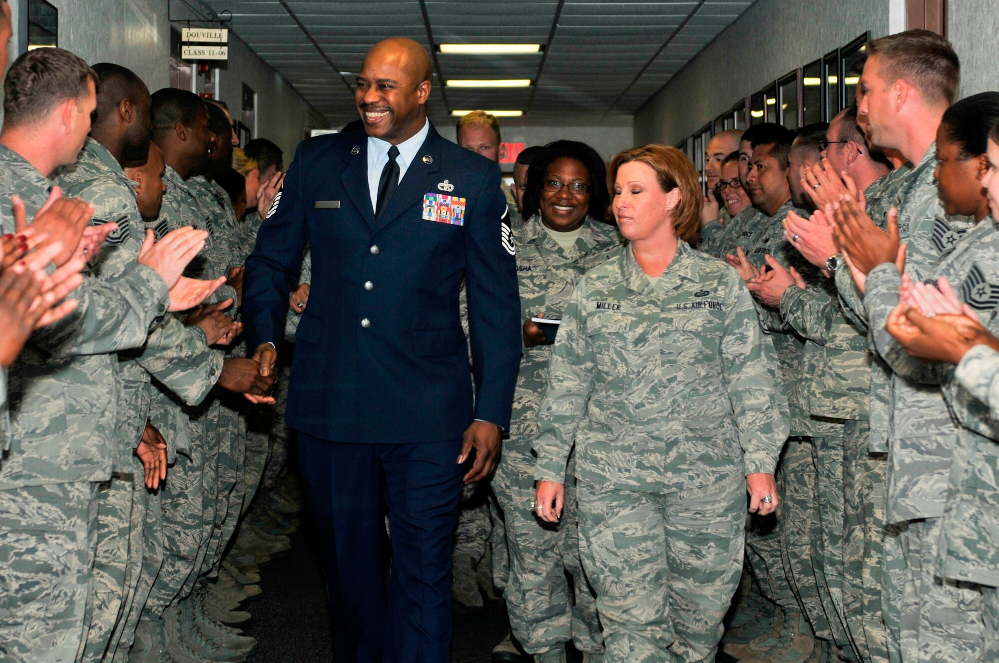 Master Sgt. Charlie Peterson, 127th Logistics Readiness Squadron vehicle operator at Selfridge Air National Guard Base, Mich. walks down a hallway lined with clapping NCOs on March 27 at the Airey NCO Academy, on Tyndall Air Force Base. The Airey NCO Academy class 13-3 dedicated their Guardian Flight room to Sergeant Peterson. (U.S. Air Force Photo by Susan Trahan)