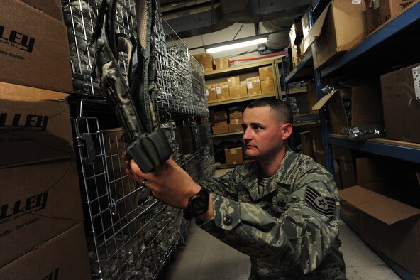 Tech. Sgt. Jeremy Sanford, 509th Security Forces Squadron NCOIC of supply, checks the serviceability of a plate carrier at Whiteman Air Force Base, Mo., March 20, 2013. Instead of using the base logistics readiness squadron to provide equipment to Airmen, the 509th SFS handles all supply matters internally. (U.S. Air Force photo by Staff Sgt. Nick Wilson/Released)