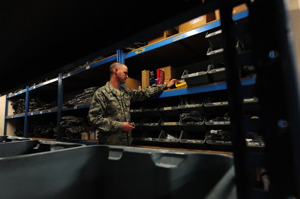 Tech. Sgt. Jeremy Sanford, 509th Security Forces Squadron NCOIC of supply, performs an inventory check on handcuffs at Whiteman Air Force Base, Mo., March 20, 2013. Sanford is responsible for accountability of more than 5,000 items totaling more than $3.2 million in value. (U.S. Air Force photo by Staff Sgt. Nick Wilson/Released)