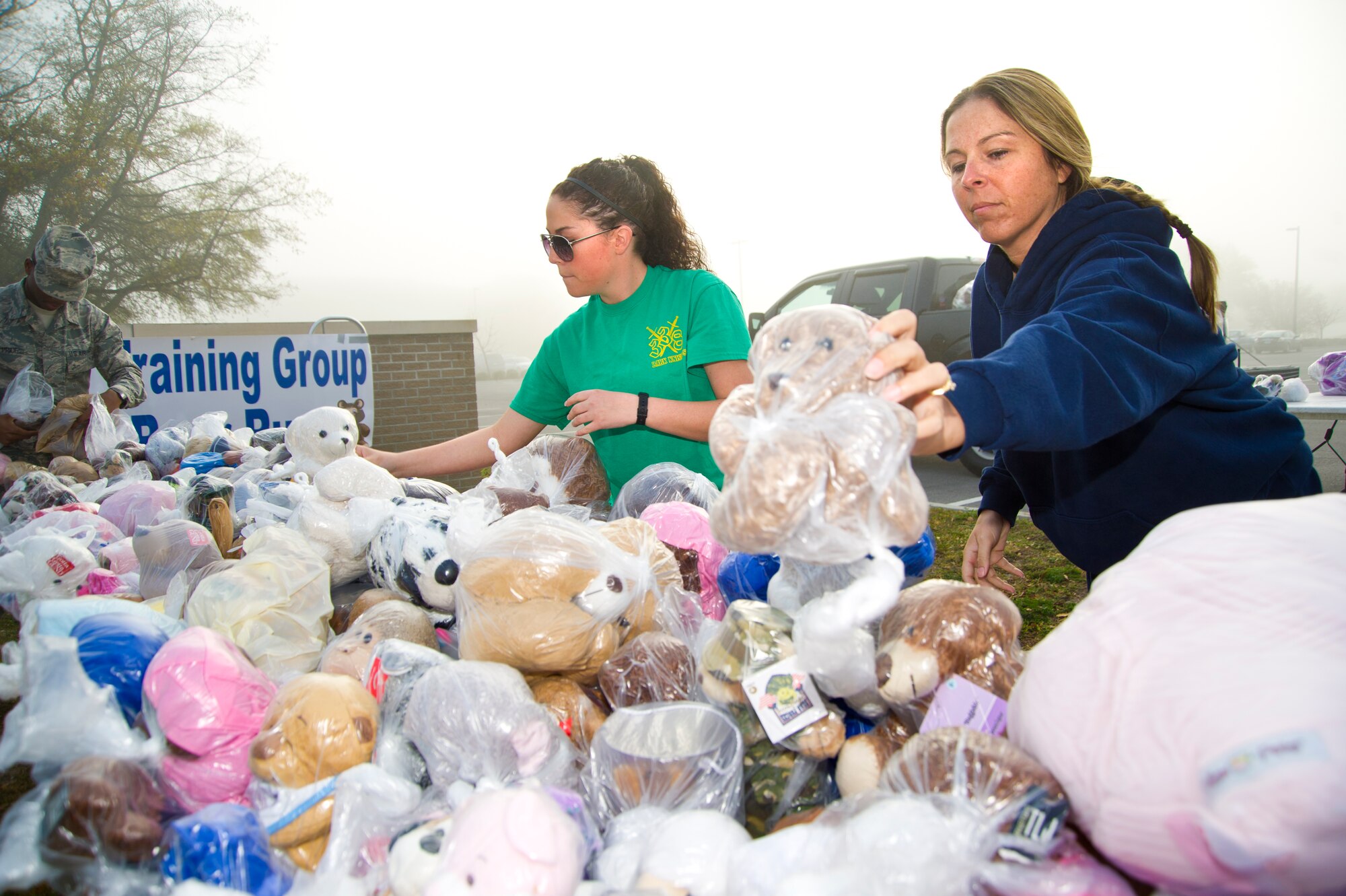 Airman 1st Class Samantha Gauthier, 338th Training Squadron, and Tech. Sgt. Julie Hammond, 81st Training Group, arrange teddy bears to be handed out to runners during a Teddy Bear Run March 29, 2013 at Keesler Air Force Base, Miss. About 750 bears were donated for the run and will be passed on to children in crisis situations.  (U.S. Air Force photo by Adam Bond)