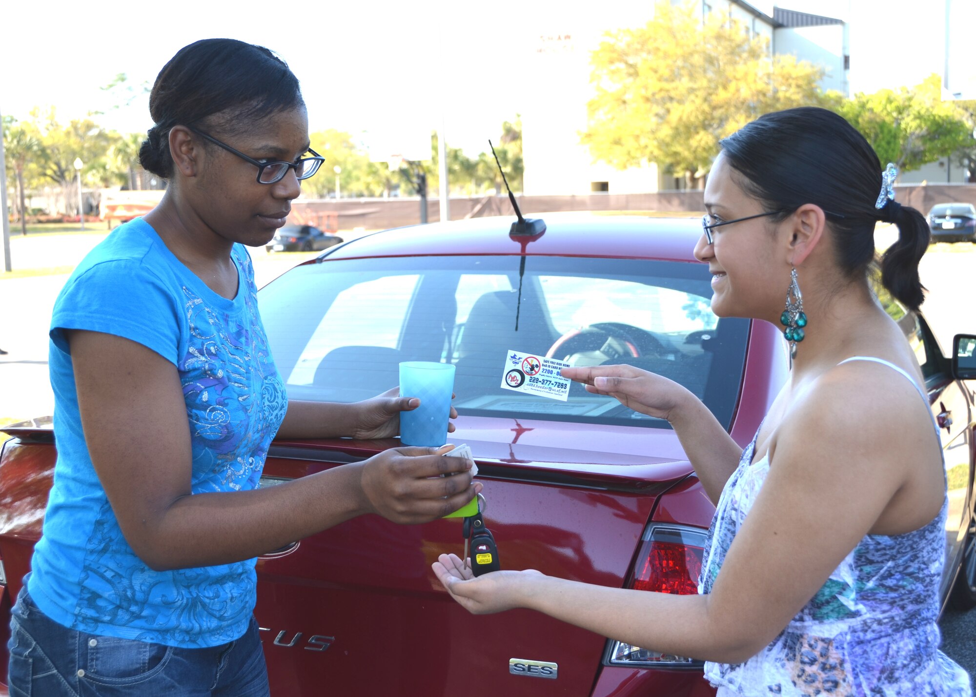 Airman 1st Class Jasmine Jorden, 81st Diagnostics and Therapeutics Squadron, hands her car key to Airman Again Drunk Driving president Senior Airman Sarah Guthrie, 81st MDTS, who passes her an A2D2 card with information about calling for an A2D2 member after drinking too much April 1, 2013.  A2D2 is a volunteer organization and may be used by anyone with a Department of Defense ID card.  Representatives may be reached at 228-377-SAVE (7283) 10 p.m. to 6 a.m. nights before non-training days and weekends. The boundaries of their service are U.S. 49 in Gulfport to Highway 57 in Gautier and two miles north of I-10.  (U.S. Air Force photo by Steve Pivnick)