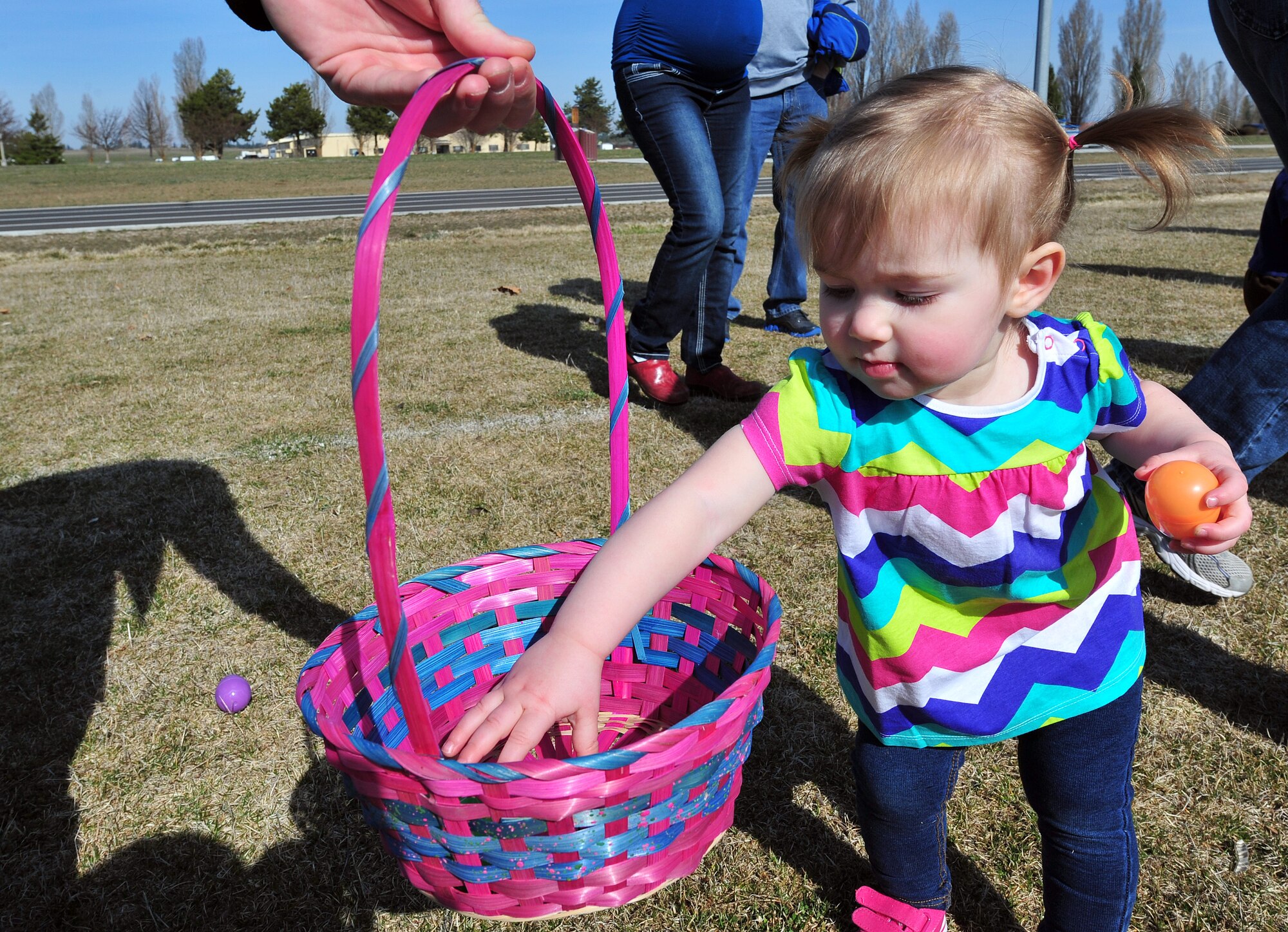 Children up to age 2 gathered candy-filled eggs during an Easter egg hunt on the football field at Fairchild Air Force Base, Wash., March 30, 2013. The event was sponsored by the Deel Community Center. (U.S. Air Force photo by Senior Airman Taylor Curry)