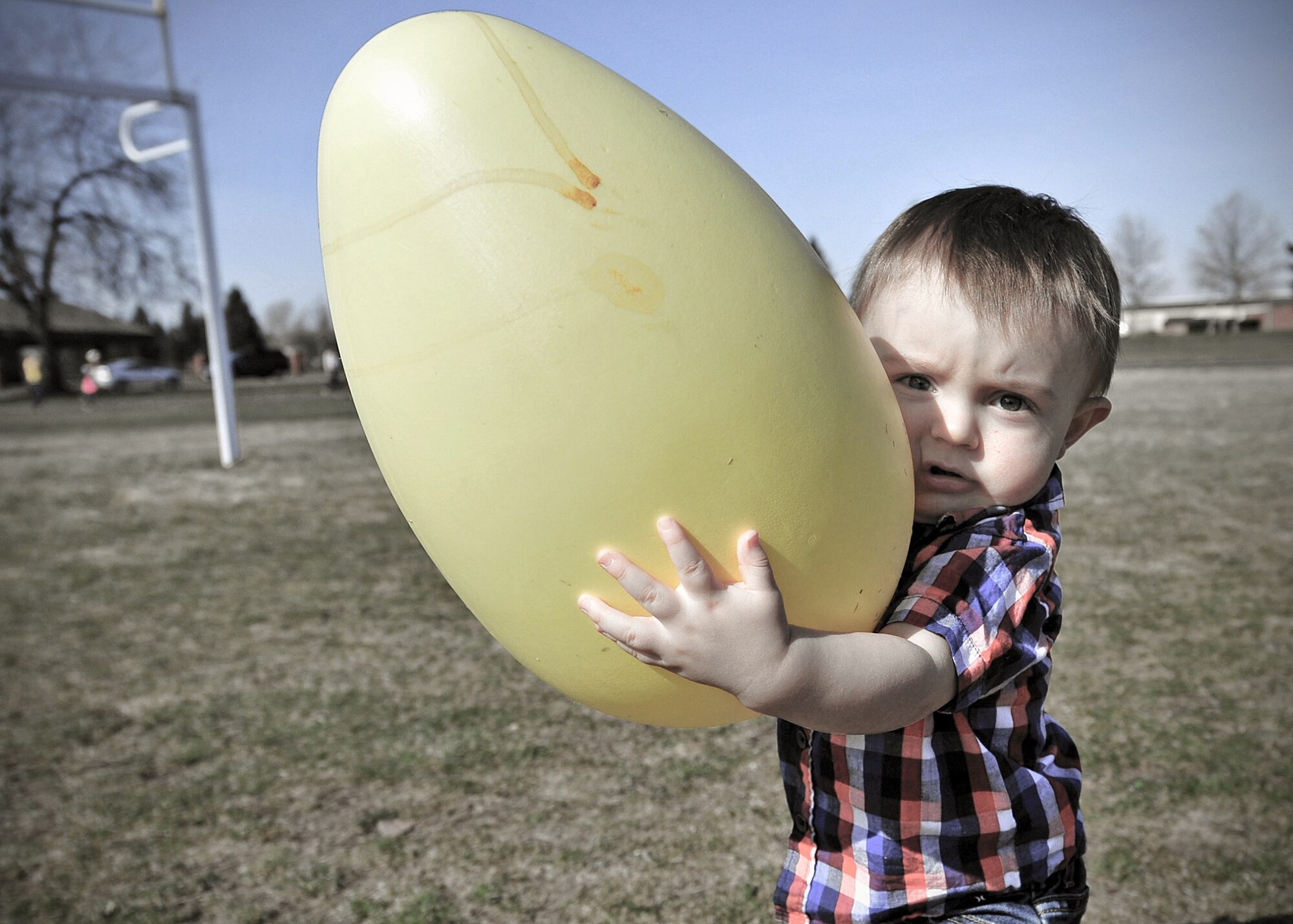 Children up to age 2 gathered candy-filled eggs during an Easter egg hunt on the football field at Fairchild Air Force Base, Wash., March 30, 2013. The event was sponsored by the Deel Community Center. (U.S. Air Force photo by Senior Airman Taylor Curry)