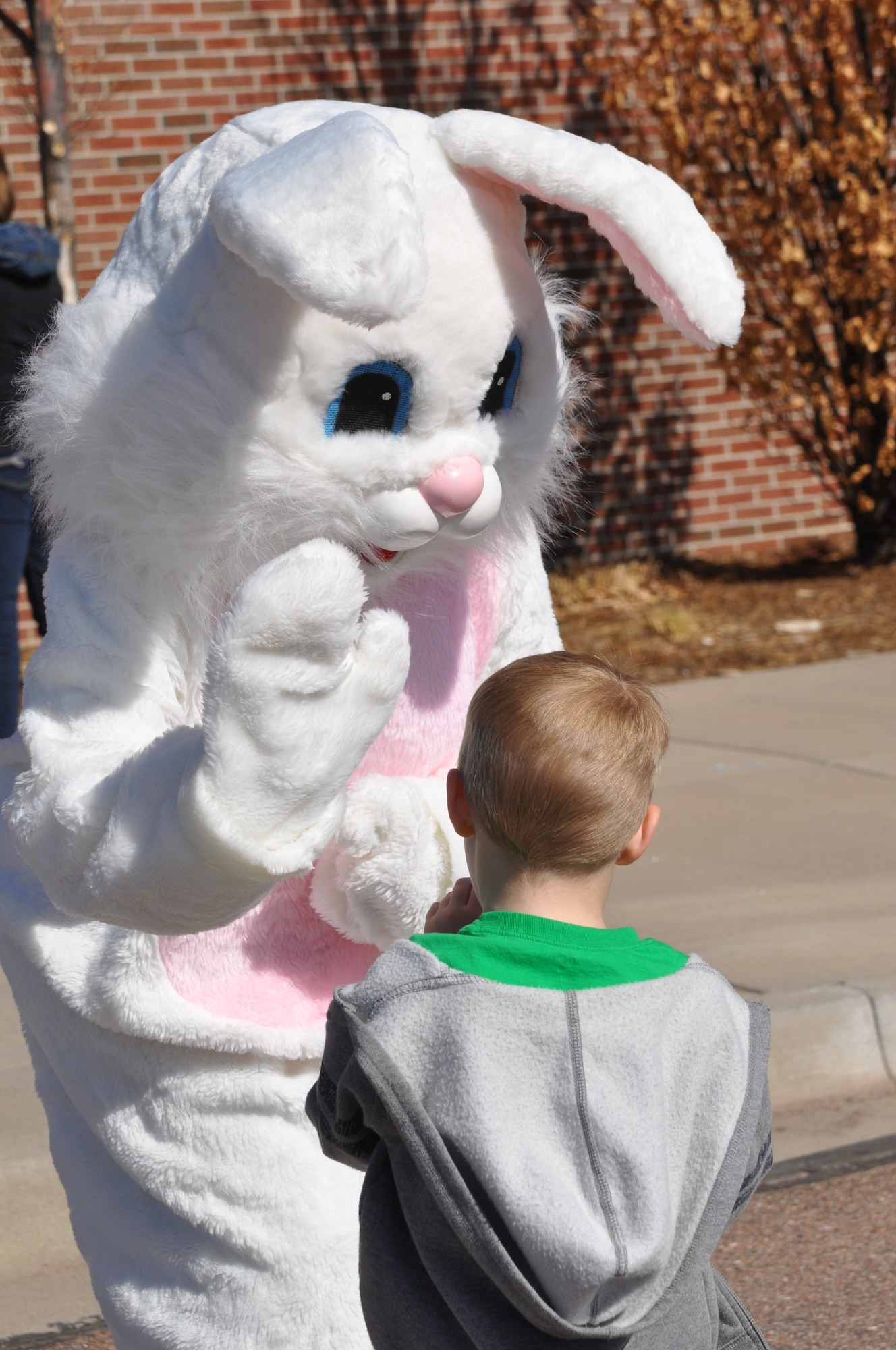 The Easter Bunny waves hello to a child March 30 at the RP Lee Youth Center as part of the Easter Egg-Stravaganza. The event, hosted by the 21st Force Support Squadron, featured the Kia Hamstars, arts and crafts by Tierra Vista Communities, and a little mermaid theme. (U.S. Air Force photo/Margaret Arnold)