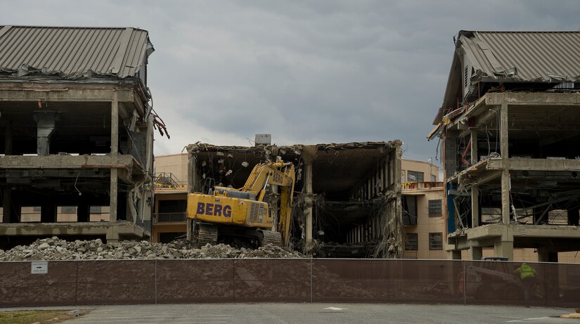 An excavator demolishes the old headquarters building March 26, 2013, at Joint Base Andrews, Md. Built in 1946, the building was home to many commands over the years before being replaced by the William A. Jones III building in 2011. (U.S. Air Force photo/Staff Sgt. Perry Aston)