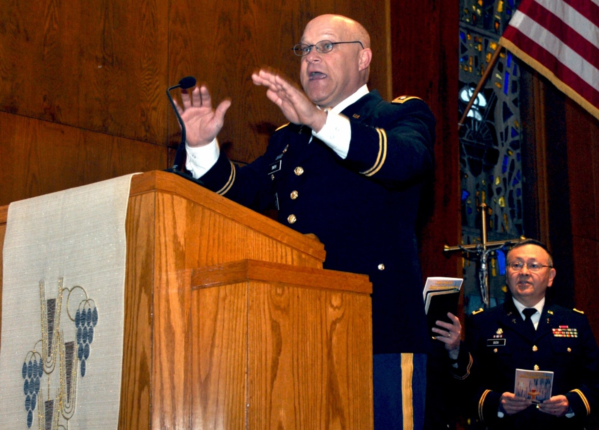 U.S. Army Chap. (Lt. Col.) Timothy Smith, Fort Eustis deputy operations chaplain, leads the congregation in song during the post's Easter Sunrise Service at the Regimental Memorial Chapel at Fort Eustis, Va., March 31, 2013. The service included inspirational music, scripture reading, and a visit from the post's former post chaplain, retired Chap. (Col.) Richard Garrison. (U.S. Air Force photo by Senior Airman Jason J. Brown/Released)
