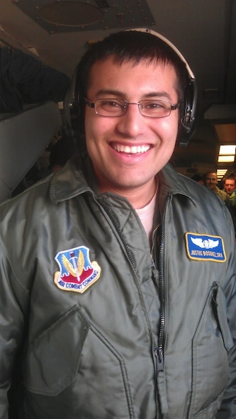 After receiving paperwork putting him back in flying status, Senior Airman Justus Bosquez took his first flight as an amputee March 25. The Airman, an E-3 air surveillance technician with the 965th Airborne Air Control Squadron, had his left leg amputated after a hit-and-run motorcycle accident in June 2011. (Courtesy photo) 
