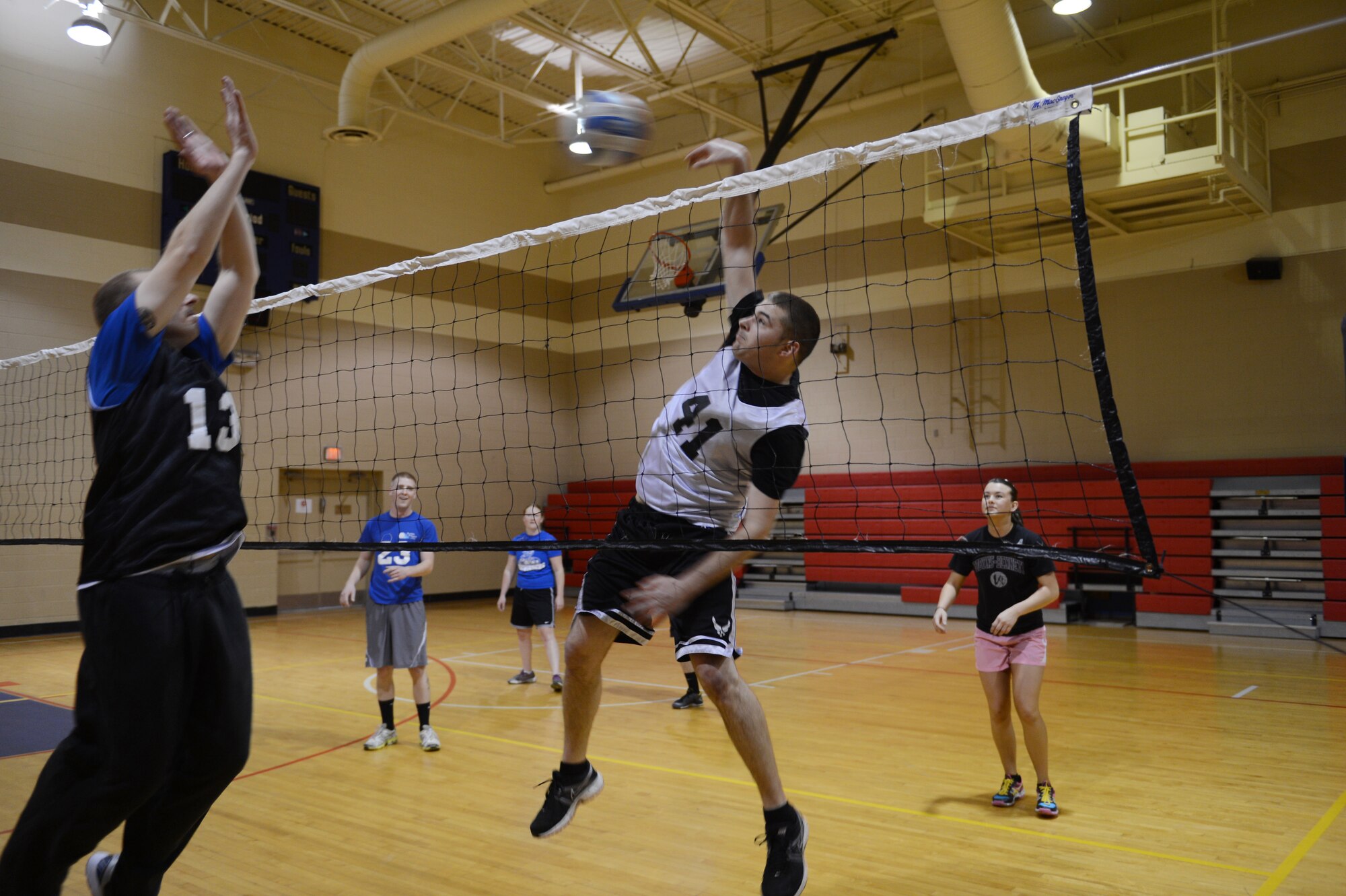 Senior Airmen Christopher O'Brath, 20th Component Maintenance Squadron electronic warfare technician and a member of the CMS volleyball team, spikes a ball over the net as Capt. Ross Brennan, 20th Fighter Wing Judge Advocate chief of adverse actions and a member of the Wing Staff Agencies team, tries to block the ball during a volleyball game at Shaw Air Force Base, S.C., March 28, 2013. There are five other teams competing in Shaw’s intramural volleyball tournament. They include the 20th Force Support Squadron, Operations Support Squadron, and Civil Engineering Squadron; 28th Operational Weather Squadron; and Air Forces Central. (U.S. Air Force photo by Airman 1st Class Krystal M. Jeffers/Released)