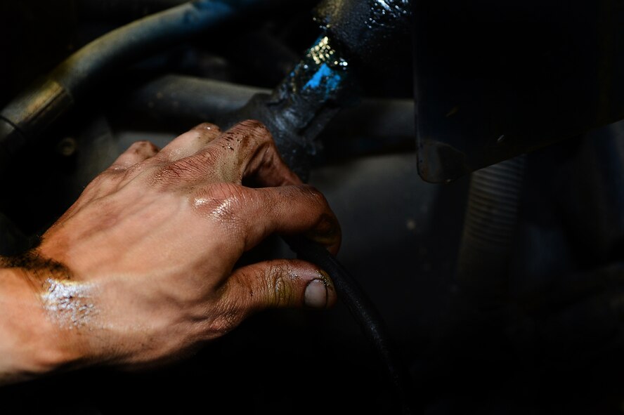 U.S. Air Force Senior Airman Matthew Holloway, 20th Logistics Readiness Squadron vehicle maintainer, greases a steering link at Shaw Air Force Base, S.C., March 29, 2013. The vehicle management flight is responsible for overall maintenance of the wing's vehicle fleet and accountability of vehicle assets, ensuring their integrity for mission capability. (U.S. Air Force photo by Airman 1st Class Nicole Sikorski/Released)