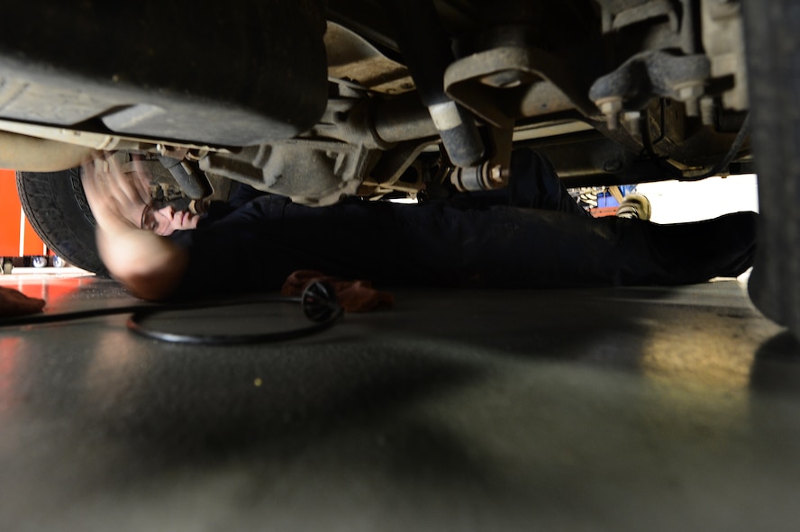 U.S. Air Force Airman 1st Class Christopher Beard, 20th Logistics Readiness Squadron vehicle maintainer, turns a wrench from underneath a vehicle at Shaw Air Force Base, S.C., March 29, 2013. The vehicle management flight is responsible for overall maintenance of the wing's vehicle fleet and accountability of vehicle assets, ensuring their integrity for mission capability. (U.S. Air Force photo by Airman 1st Class Nicole Sikorski/Released)