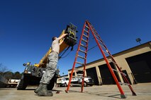 U.S. Air Force Airman 1st Class Caleb Farmer, 20th Logistics Readiness Squadron vehicle maintainer, puts safety markings on a crane at Shaw Air Force Base, S.C., March 29, 2013. The vehicle management flight is responsible for overall maintenance of the wing's vehicle fleet and accountability of vehicle assets, ensuring their integrity for mission capability. (U.S. Air Force photo by Airman 1st Class Nicole Sikorski/Released)