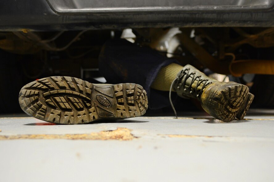 U.S. Air Force Airman 1st Class Christopher Beard, 20th Logistics Readiness Squadron vehicle maintainer, works from underneath a vehicle at Shaw Air Force Base, S.C., March 29, 2013. The vehicle management flight is responsible for overall maintenance of the wing's vehicle fleet and accountability of vehicle assets, ensuring their integrity for mission capability. (U.S. Air Force photo by Airman 1st Class Nicole Sikorski/Released)