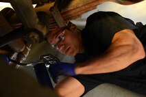 U.S. Air Force Senior Airman Matthew Holloway, 20th Logistics Readiness Squadron vehicle maintainer, greases a break chamber from underneath a truck at Shaw Air Force Base, S.C., March 29, 2013.  The vehicle management flight is responsible for overall maintenance of the wing's vehicle fleet and accountability of vehicle assets, ensuring their integrity and mission capability. (U.S. Air Force photo by Airman 1st Class Nicole Sikorski/Released)