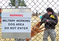 A warning sign is observed on the fence line of the military working dog area to inform people not to enter the area at Fairchild Air Force Base, Wash., March 20, 2013. Military working dog handlers train with their dogs inside the perimeter. (U.S. Air Force photo by Senior Airman Taylor Curry)