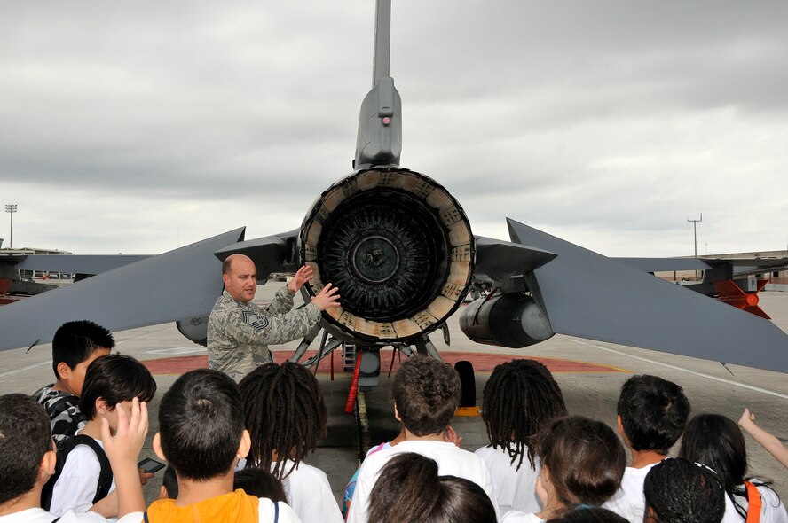 Chief Master Sgt. Robert Michalak, 482nd Aircraft Maintenance Squadron superintendent describes how an F-16 jet engine after burner works during a base tour on March 22.  Thirty-five students from Miami’s Read2Succed took part in the 482nd Fighter Wing Public Affairs tour program.  Read2Succed is a non-profit after school program specializing in targeting literacy amongst youth as well providing children the necessary tools and resources to achieve academic success. Information to schedule a base tour can be found at: http://www.homestead.afrc.af.mil/questions/index.asp (U.S. Air Force photo/Tim Norton)