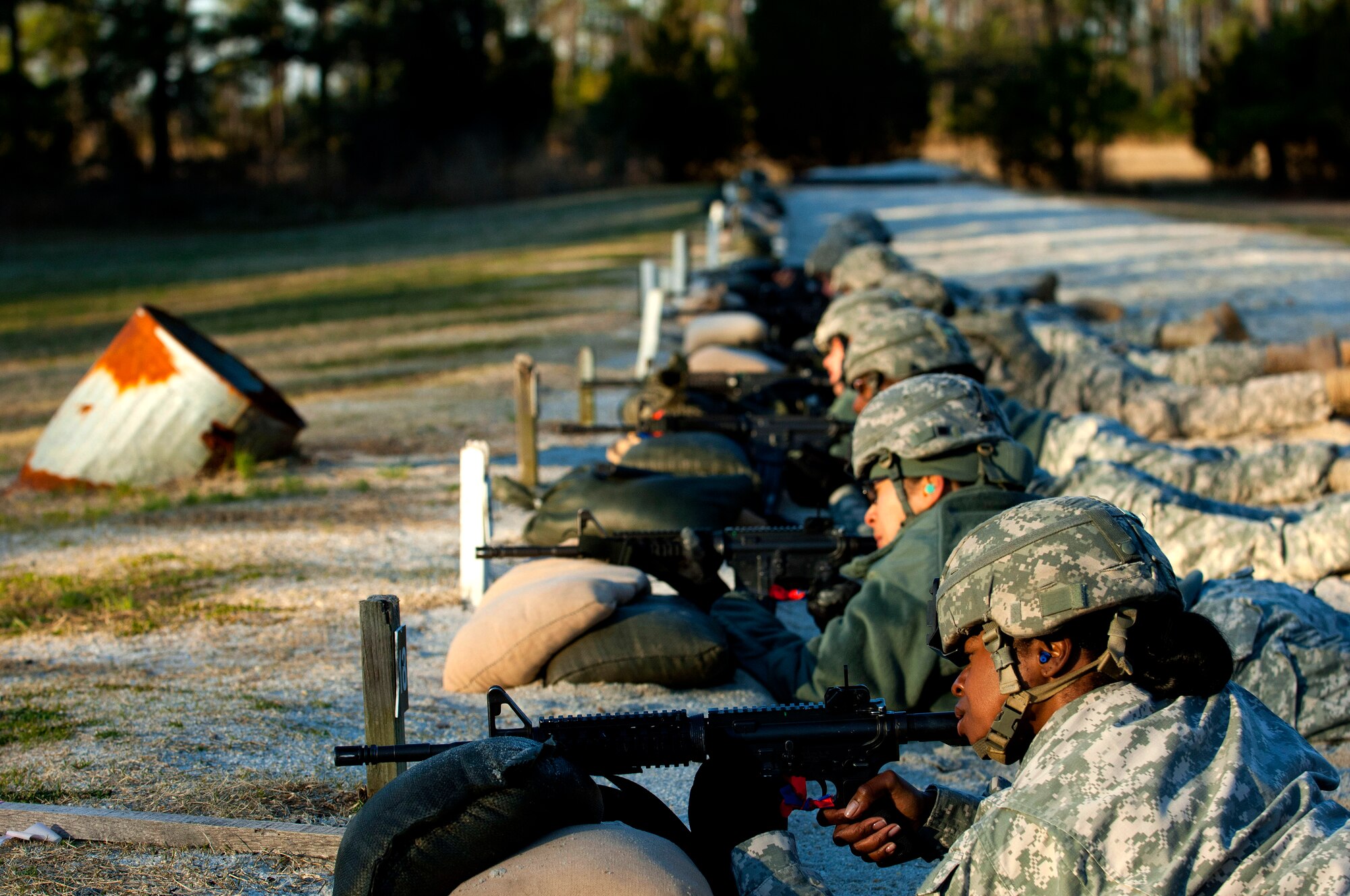 Soldiers from the 597th Transportation Brigade prepare their weapons on Range 2 during the rifle qualification portion of the brigade's Best Warrior Competition at Fort Eustis, Va., March 27, 2013. In addition to rifle qualification, competitors were tested on military knowledge, physical fitness, marksmanship and Army warrior tasks and drills. (U.S. Air Force photo by Airman 1st Class R. Alex Durbin/Released)
