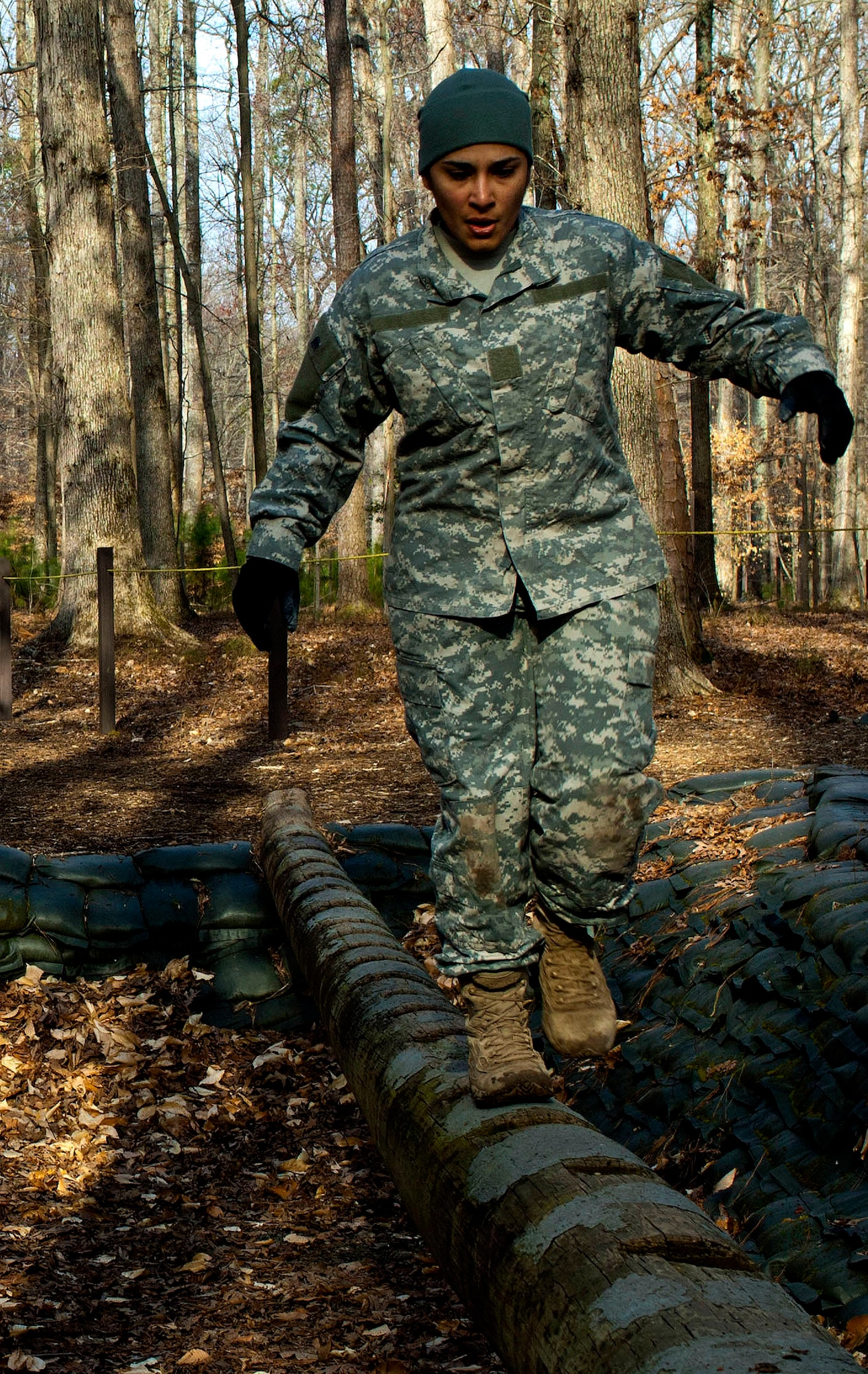 U.S. Army Sgt. Claribel Lopez Feliciano, 688th Rapid Port Opening Element management coordinator, walks across the balancing log during the obstacle course portion of the 597th Transportation Brigade’s annual Best Warrior Competition at Fort Eustis, Va., March 28, 2013. The obstacle course portion of the competition is meant to test the participants’ physical fitness and the skills need of all Soldiers on and off the battlefield.  (U.S. Air Force photo by Airman 1st Class R. Alex Durbin/Released)